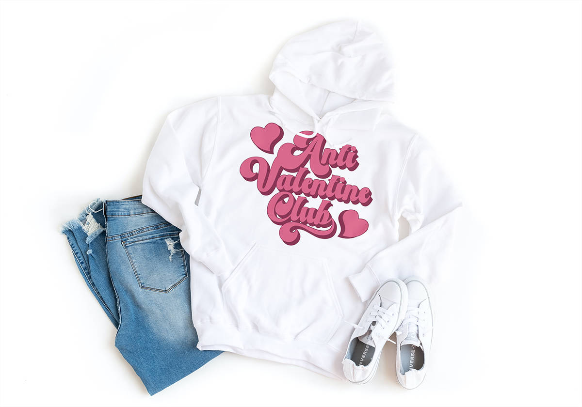 A white hoodie with the words Valentine's Day and the Anti-Valentine Club logo.