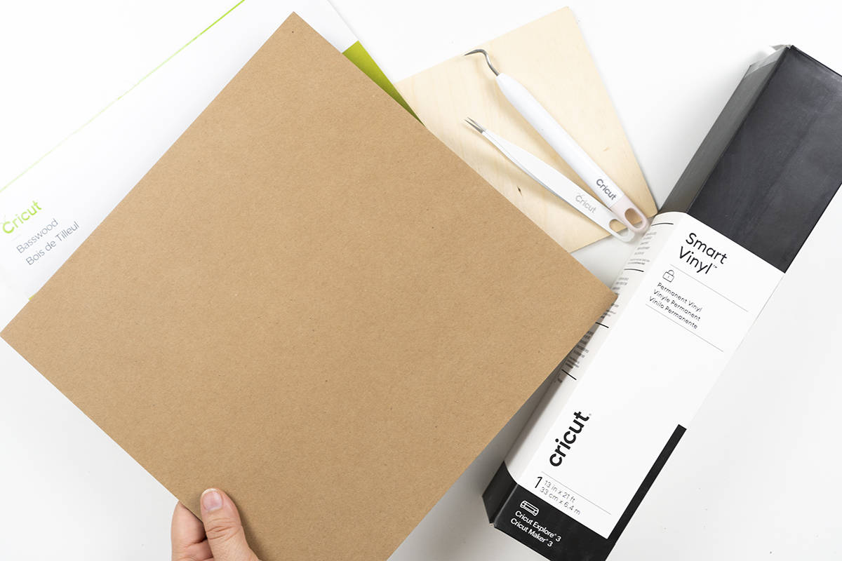 A person is holding a Cricut materials