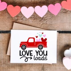 Valentine's day card with a red truck and hearts.