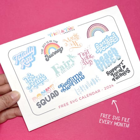 A hand holding a Tried & True Creative Free SVG File calendar.