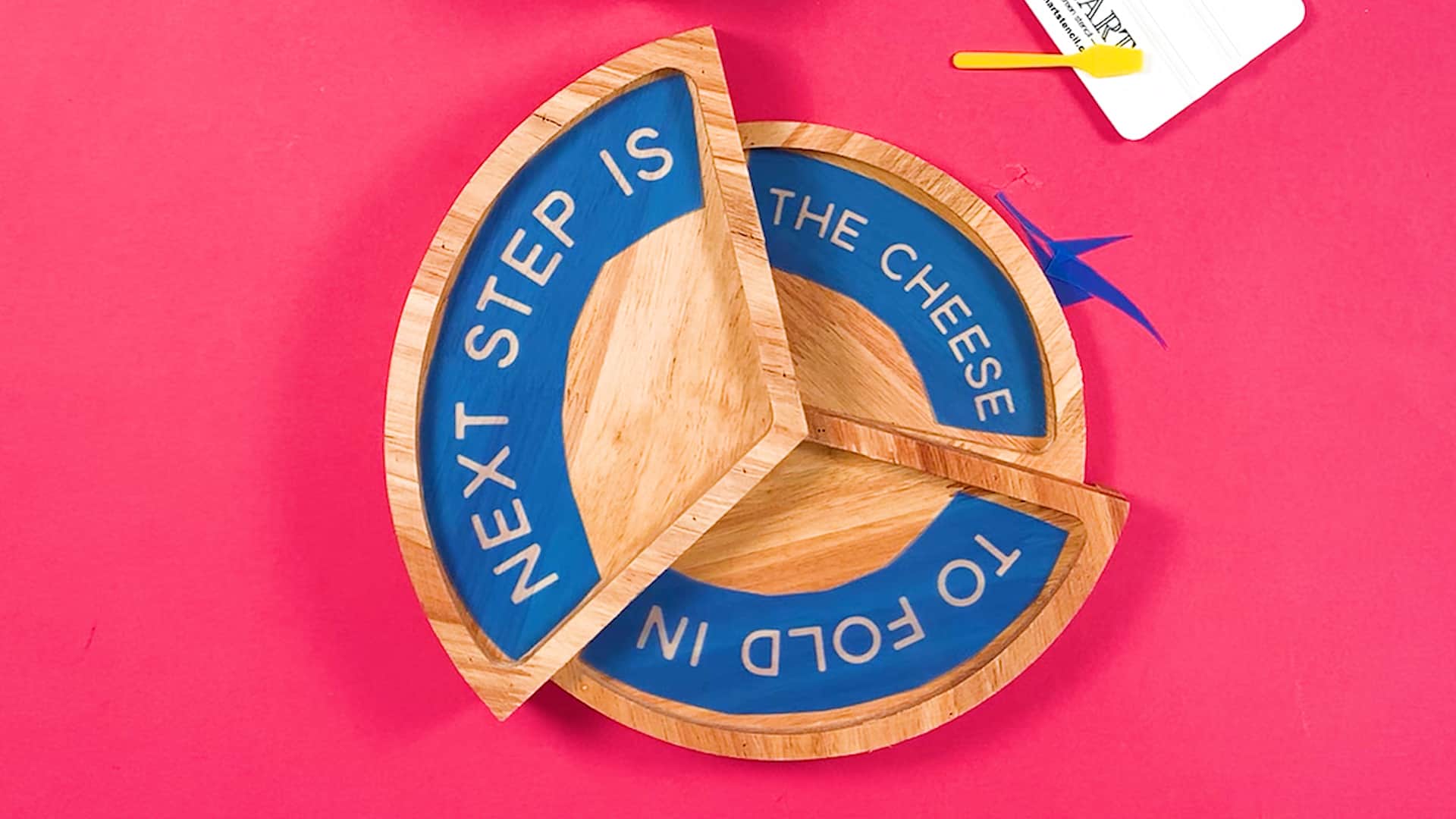 A wooden board with the words step is the cheese.