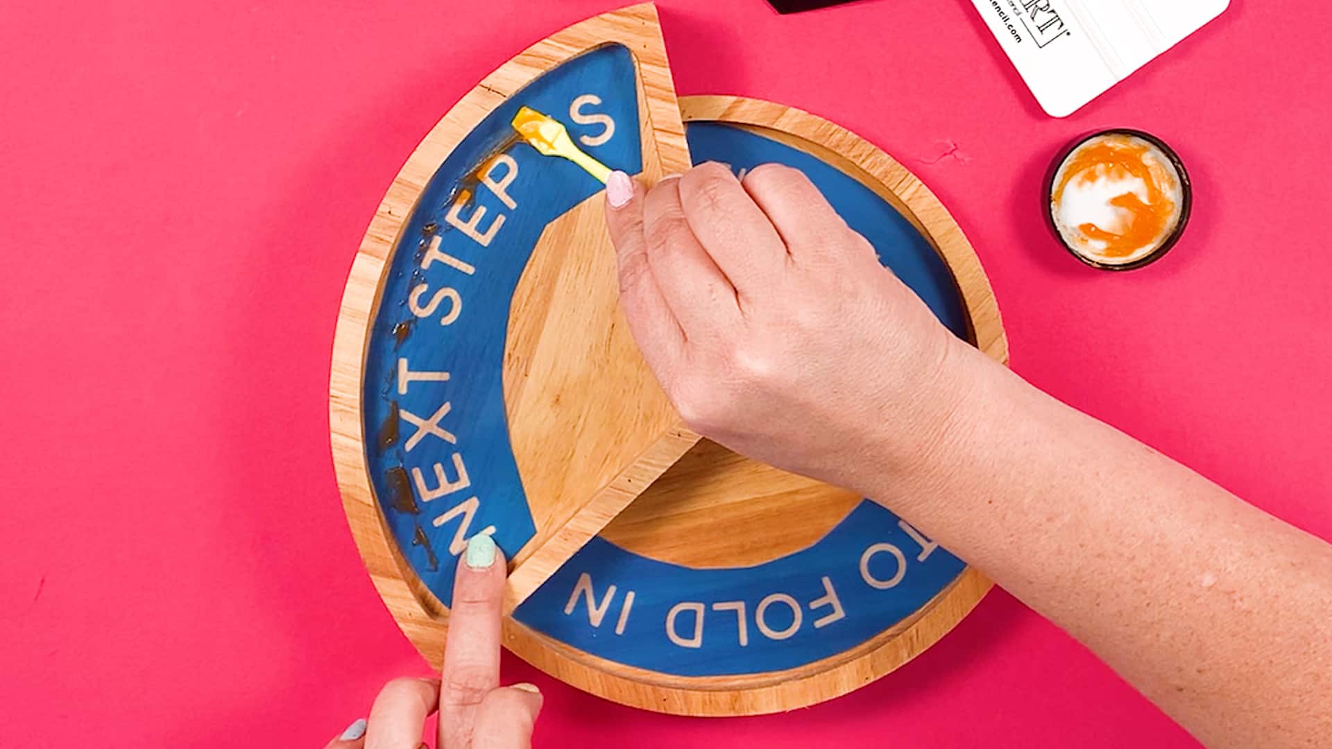 A person is putting Torch Paste on a wooden board.