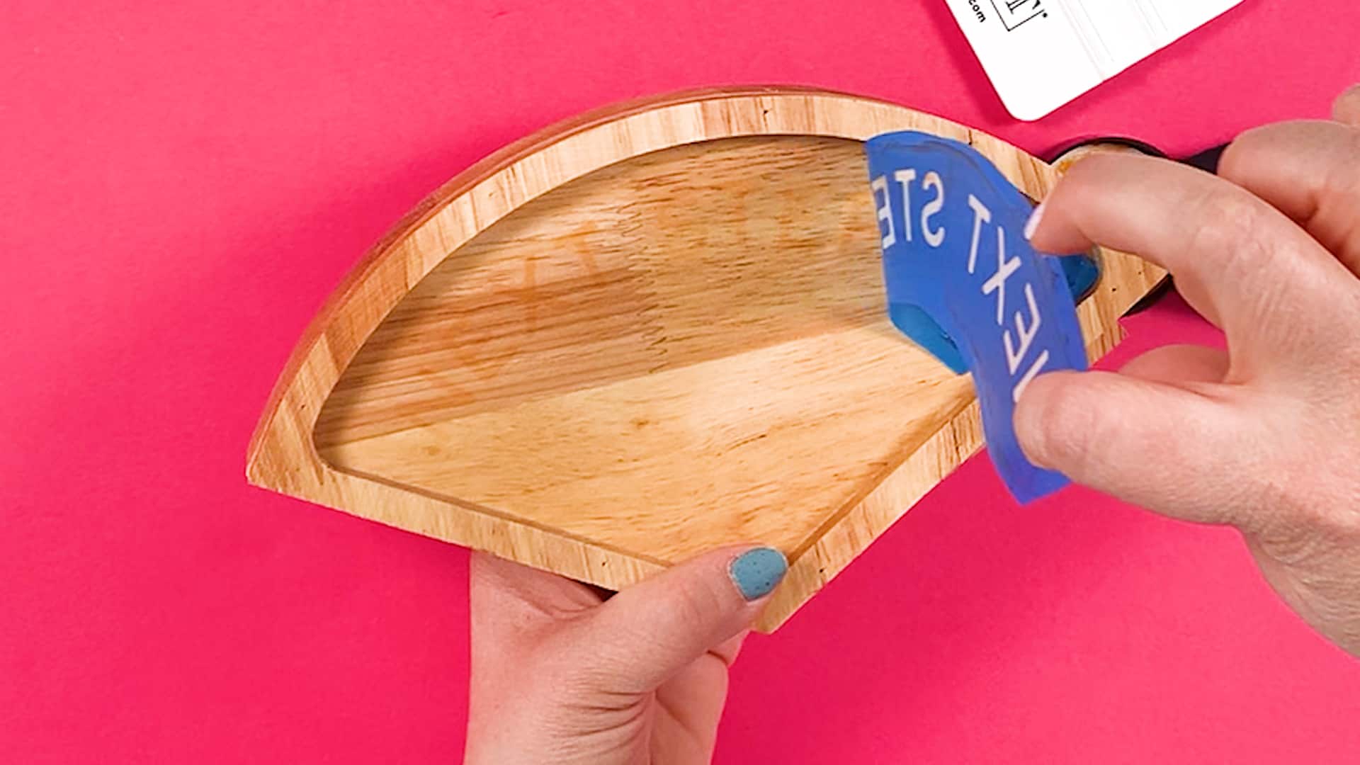 A person cutting removing an Ikonart Stencil