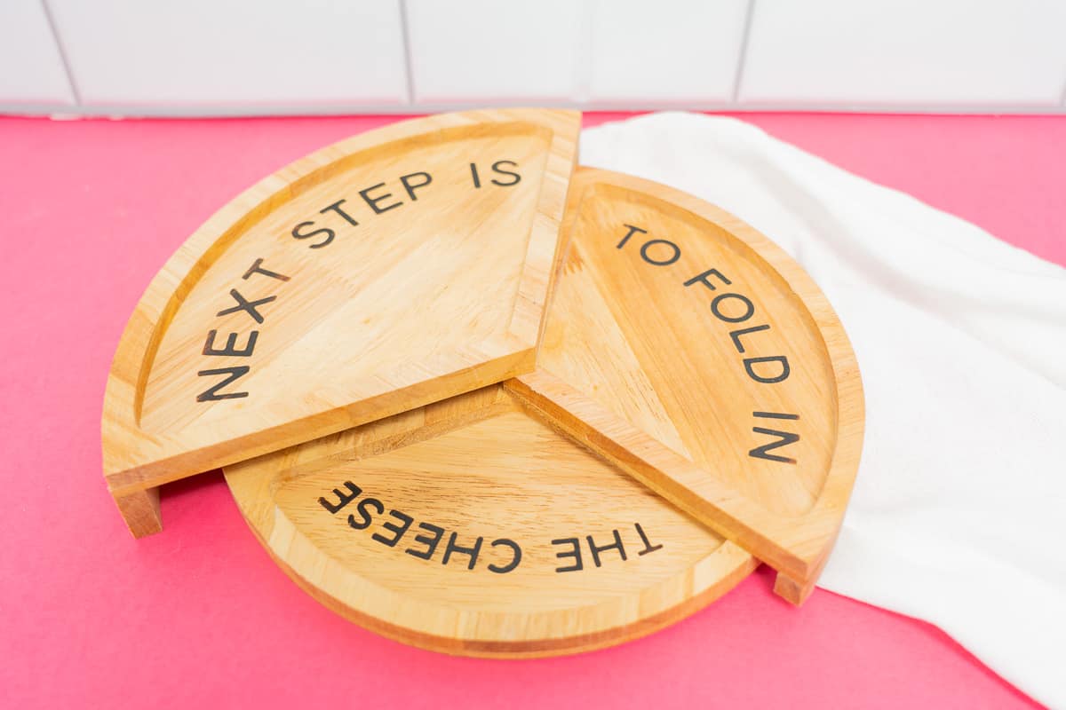 Schitt's Creek Cheese Board that has wood etched with "Next step is to fold in the cheese."